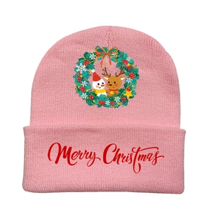 Detail of pink knitted beanie featuring Merry Christmas text and festive wreath print
