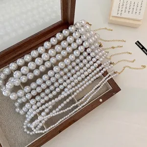 French vintage pearl necklaces in various sizes with gold clasps on a wood box