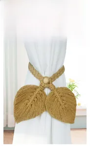 Bohemian curtain tieback with handcrafted leaf design and natural wooden bead detail