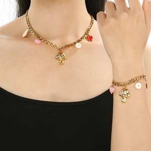 Gold stainless steel mushroom and heart charm jewelry set worn on neck and wrist