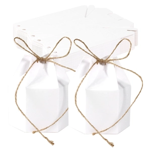 Detail of white hexagonal paper gift boxes with hemp rope bows and flat cardboard