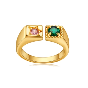 Detail of adjustable gold ring featuring a pink star zircon and a green round gemstone