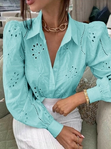 Close-up of light blue hollow embroidery detailing on a stylish lapel shirt for women