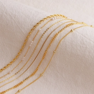 Minimalist gold plated copper necklace set with pearl and layered chain designs