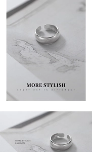 Macro detail of a polished S925 sterling silver wide minimalist open adjustable ring band
