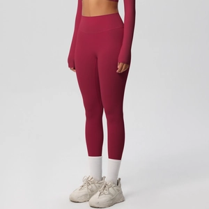 Detail of high-waisted dark red yoga leggings in brushed moisture-wicking fabric