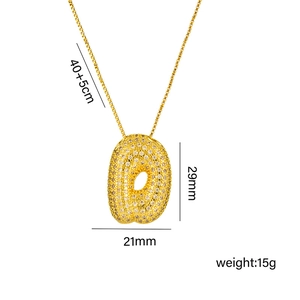 Gold bubble letter O necklace with zircon stones on white background and dimensions