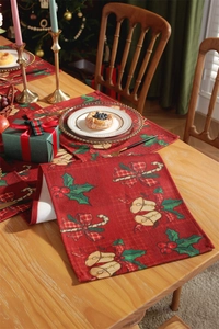 Close-up of festive Christmas placemat with bell patterns on a wooden dining table