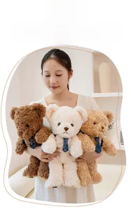 Three plush teddy bears in brown, cream, and tan colors with elegant blue ties