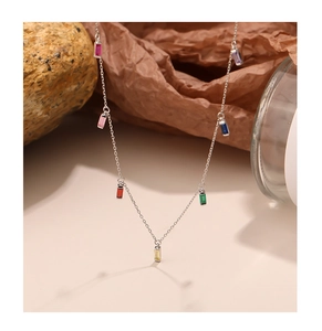 Macro shot of 925 silver necklace with multi-colored cubic zirconia pendants on stone