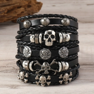 Detail view of multi-layer black leather punk bracelets with skull and rivet accents