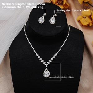 Detail of cubic zirconia bridal jewelry set featuring necklace and earrings on a model