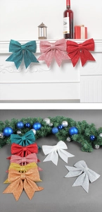 Detail of glittery Christmas bows on a festive mantel with warm holiday decorations