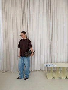 Brown T-shirt with lace trim details and back split design paired with wide-leg jeans