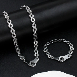Detailed close-up of polished infinity link chain and handcuffs clasp jewelry