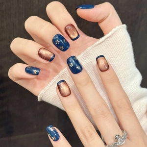 Starry sky press-on nails in navy blue and copper cat eye with glitter floral art