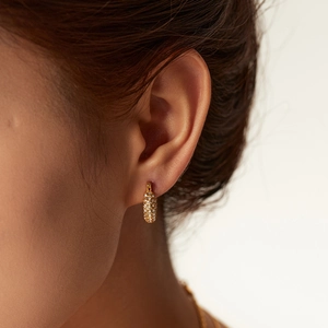 18K gold plated stainless steel hoop earrings with white cubic zirconia on female model