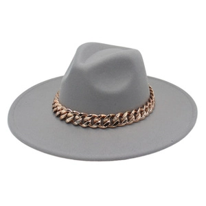 Detail of grey wool fedora hat featuring a chunky rose gold acrylic chain decoration