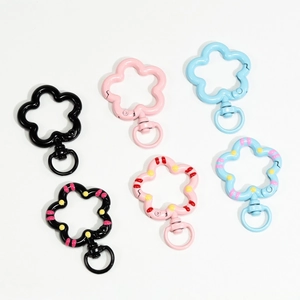 Flower-shaped colorful spring ring keychains in black, pink, and light blue finishes