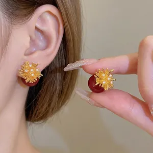 18k gold plated sunburst stud earrings with zircons and red resin bead details