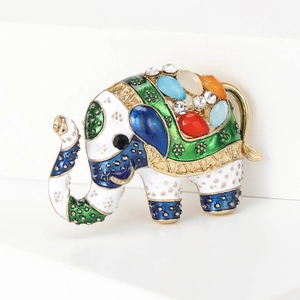 Detailed view of enamel elephant brooch featuring colorful rhinestones and gold-tone finish
