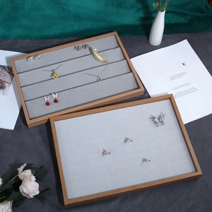 Minimalist wooden jewelry display tray with grey velvet lining for rings and necklaces