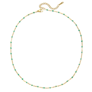Detail of gold chain necklace featuring green enamel beads and adjustable clasp closure