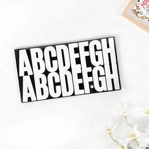 Close-up of black and white 2.5-inch adhesive letter stickers A-H for mailbox decor