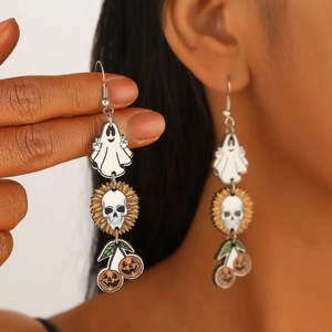 Detail shot of Halloween wooden earrings with ghost and pumpkin charms on a model