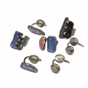 Detailed collection of vintage raw gemstone adjustable rings on white background
