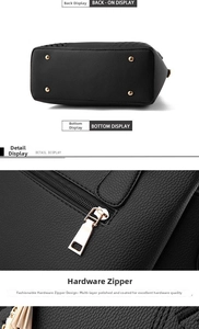 Detail view of black leather handbag featuring gold metal feet and polished zipper
