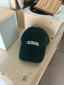 Detailed embroidery of COLORADO text on a dark green brushed cotton baseball cap