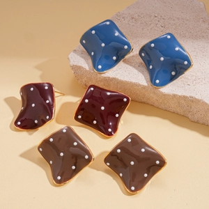Irregular geometric square earrings with polka dots and gold trim in blue red and brown