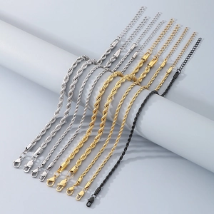 Detail of twisted rope anklets in gold silver and black with lobster clasps