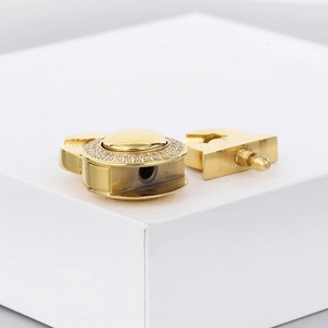 Macro view of a gold-plated toggle clasp set with shimmering pave-set cubic zirconia