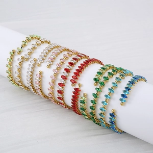Macro shot of 18K gold plated bangles with colorful marquise-cut cubic zirconia crystals