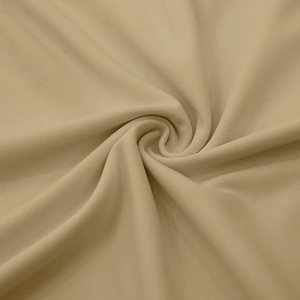 Macro shot of soft beige knit fabric texture showing the premium woven details