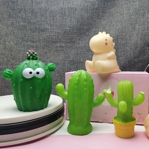 Set of cute cartoon LED night lights featuring green cactus and beige dinosaur characters