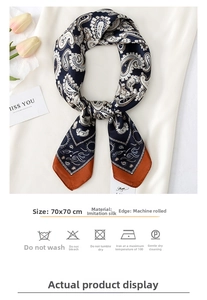 Detailed view of navy and caramel paisley silk scarf with 70x70cm size label and washing icons
