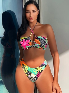 Detail of high-waist bikini with tropical floral print and halter neck cutout