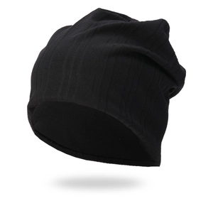Detailed close-up showing the vertical ribbed knit texture of a black winter beanie hat
