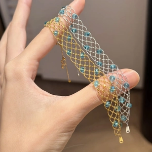 Detailed macro view of S925 sterling silver woven mesh bracelet with blue crystals