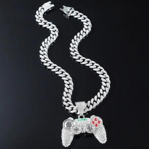 Detailed close-up of icy iced out game controller pendant with green and red rhinestones
