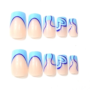 Detail of blue and nude pink square press-on nails with abstract heart and wave patterns