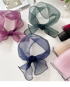 Detail of sheer organza bow hair ties in multiple colors with delicate black edge stitching