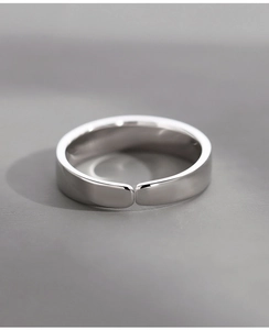 Detail view of the silver copper alloy ring showing smooth texture and adjustable band