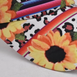 Detail of floral and leopard print baseball cap brim with precise stitching lines