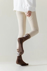 Detail view of brown yoga toe socks with cute white rabbit and anti-slip silicone soles
