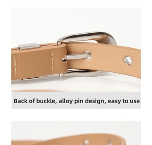 Detail view of the silver alloy buckle back and metal eyelets on a khaki leather belt