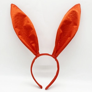 Detailed close-up of shiny orange satin rabbit ear headband for Easter costume party
